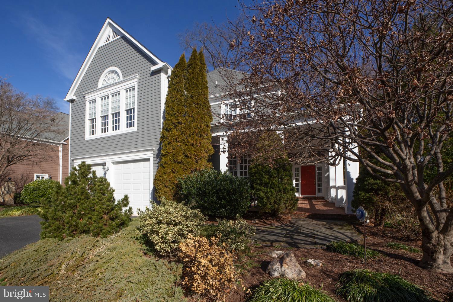 10505 Democracy Lane Potomac, MD 20854 - Photo 1 of 47 a view of a brick house with a yard and large tree