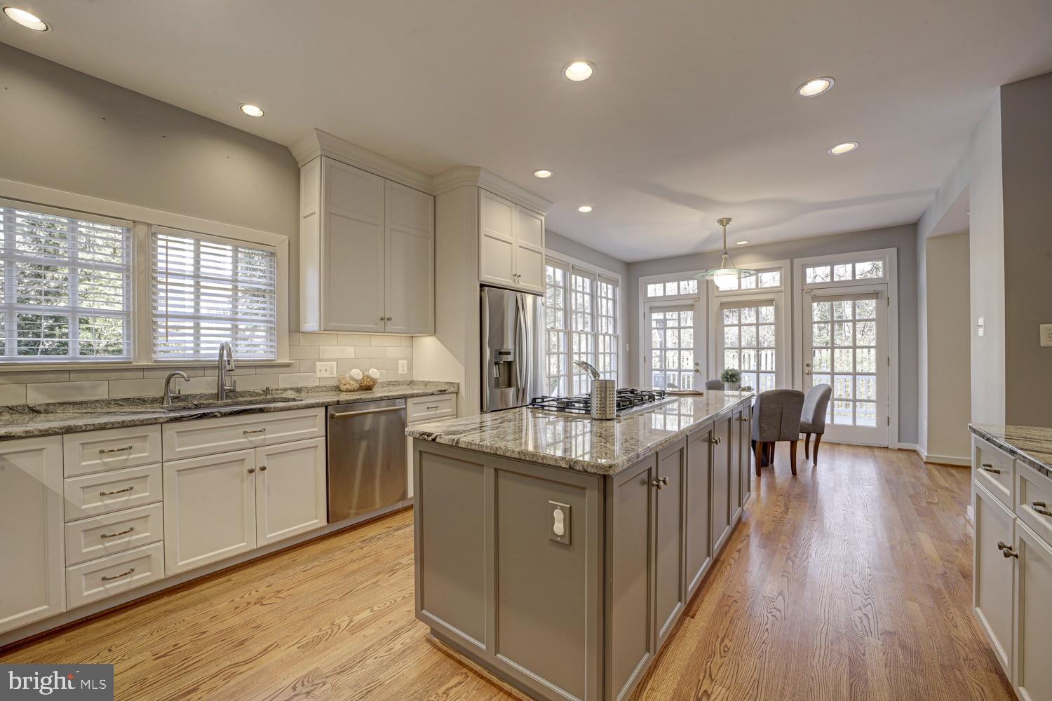 10505 Democracy Lane Potomac, MD 20854 - Photo 11 of 47 a kitchen with granite countertop center island wooden floor and stainless steel appliances