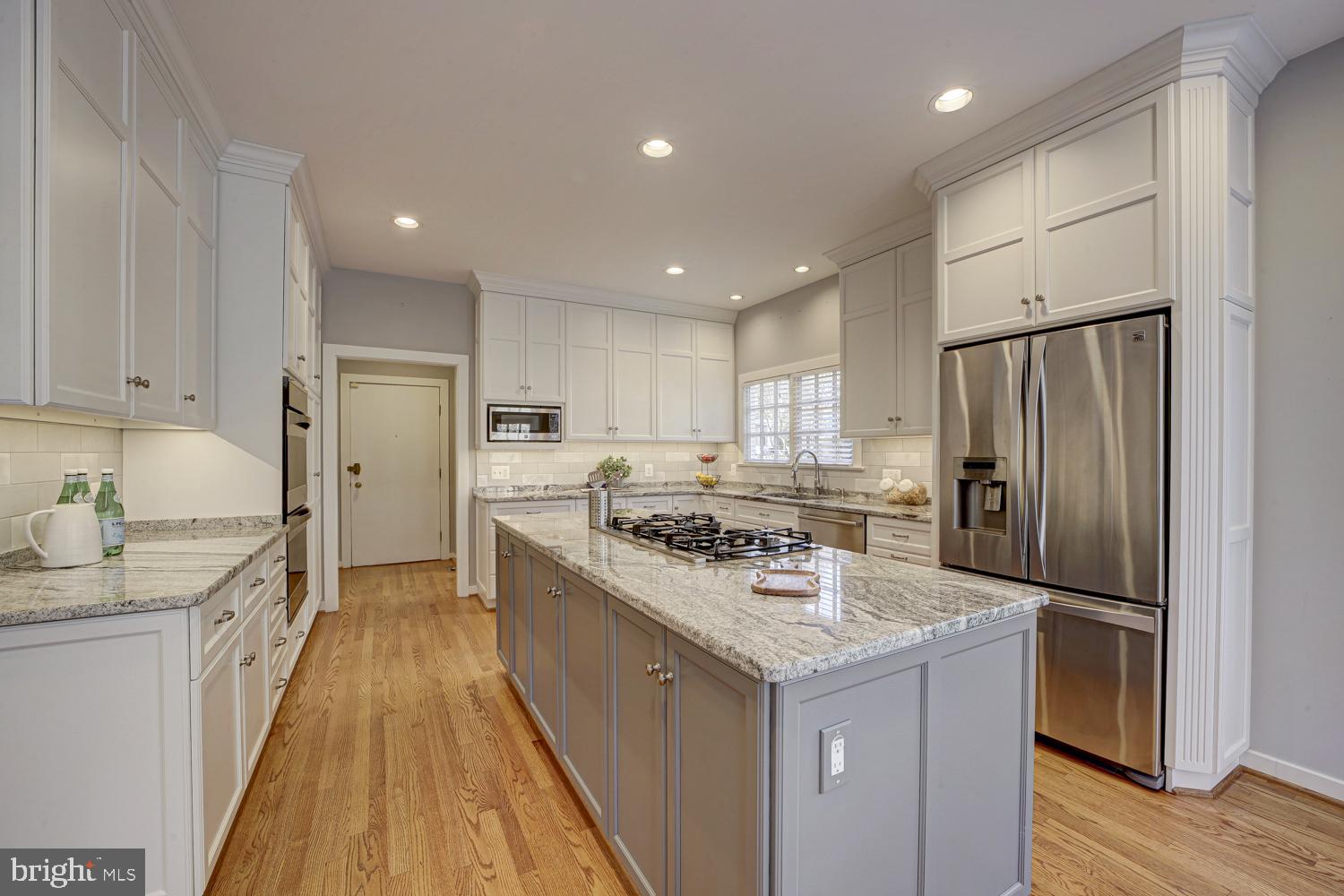 10505 Democracy Lane Potomac, MD 20854 - Photo 13 of 47 a kitchen with stainless steel appliances granite countertop a refrigerator a sink and a stove