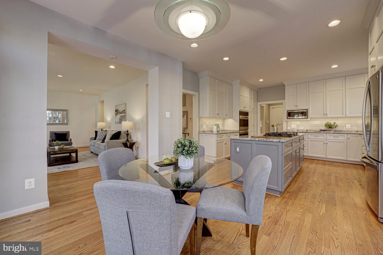 10505 Democracy Lane Potomac, MD 20854 - Photo 15 of 47 a living room with stainless steel appliances kitchen island granite countertop furniture and a wooden floor
