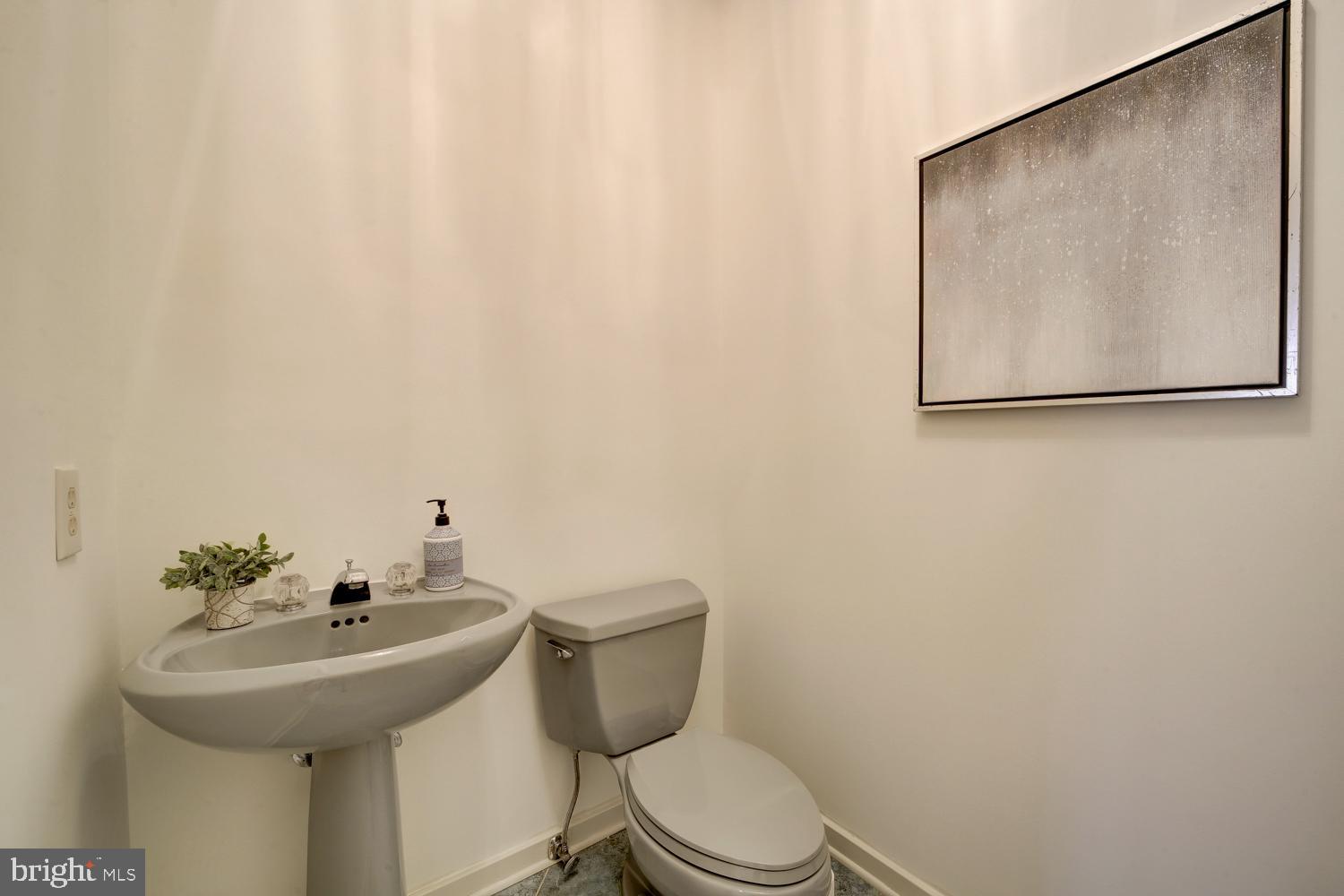 10505 Democracy Lane Potomac, MD 20854 - Photo 22 of 47 a bathroom with a toilet sink and mirror