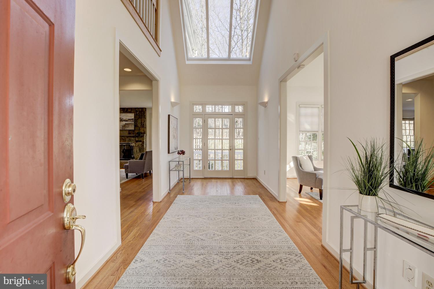 10505 Democracy Lane Potomac, MD 20854 - Photo 4 of 47 a view of a hallway with wooden floor and a living room