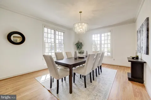a view of a dining room with furniture wooden floor and a chandelier