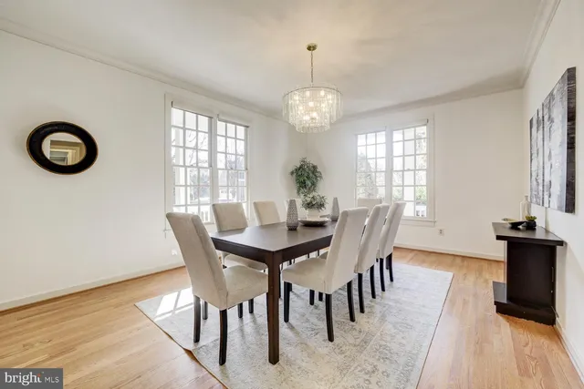 a view of a dining room with furniture wooden floor and a chandelier