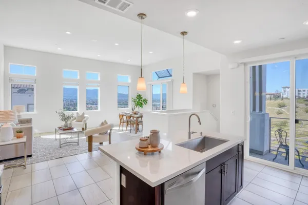 a kitchen with granite countertop a sink and cabinets