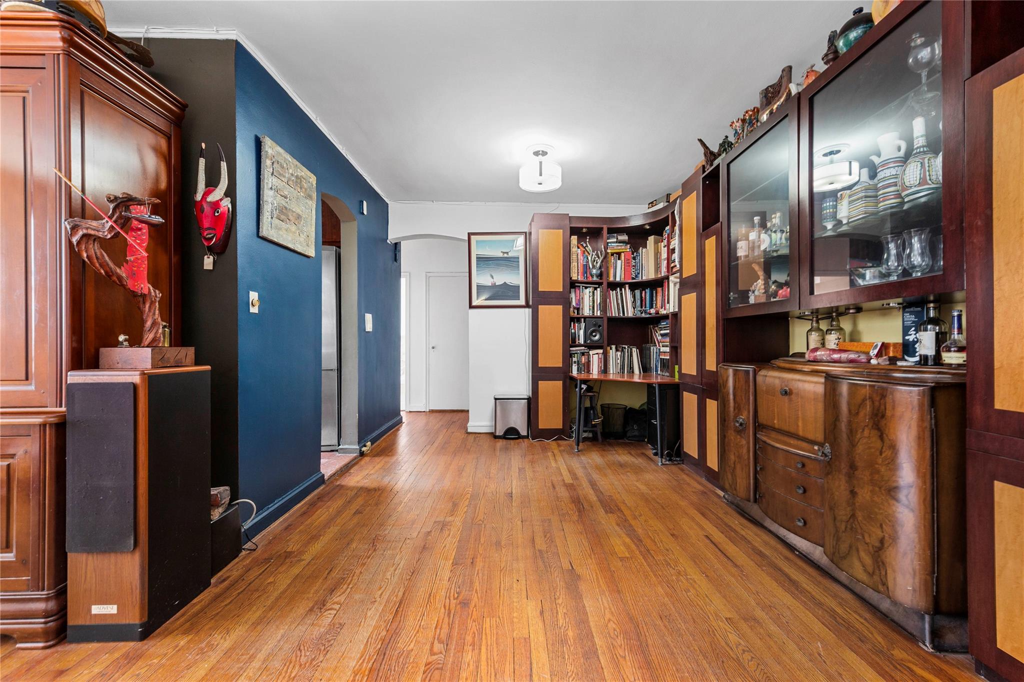 22-20 78th Street, Unit A3 Queens, NY 11370 - Photo 5 of 10 Office area with arched walkways, baseboards, and hardwood / wood-style flooring