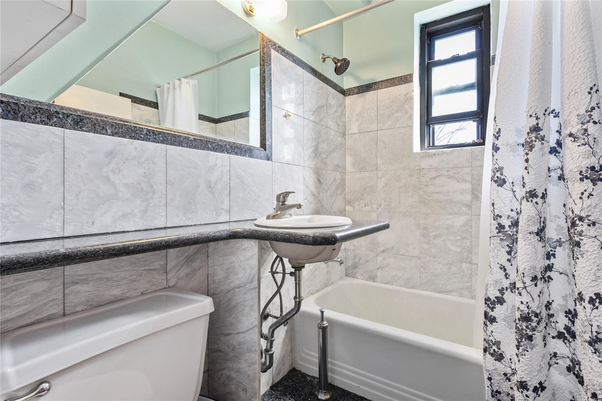 22-20 78th Street, Unit A3 Queens, NY 11370 - Photo 8 of 10 Full bathroom featuring shower / tub combo, toilet, and tile walls