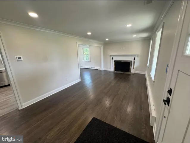 wooden floor in an empty room with a fireplace