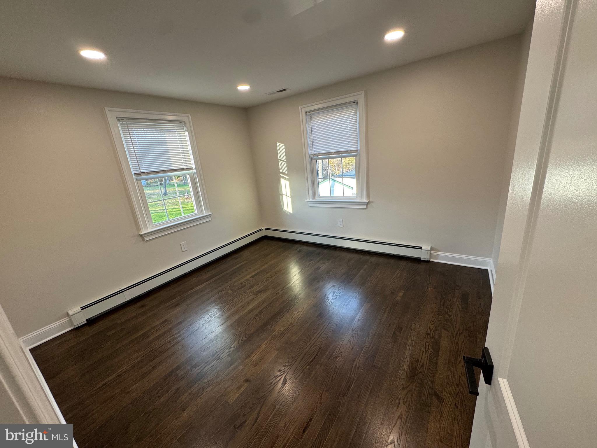 55 Apple Hill Road Furlong, PA 18925 - Photo 14 of 30 an empty room with wooden floor and windows