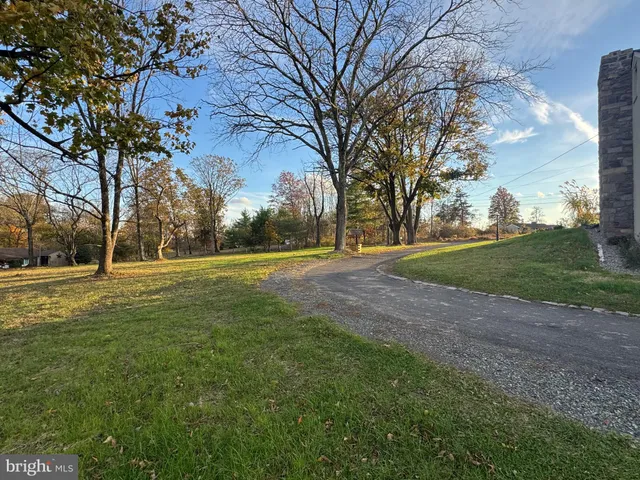 a view of backyard of house with green space