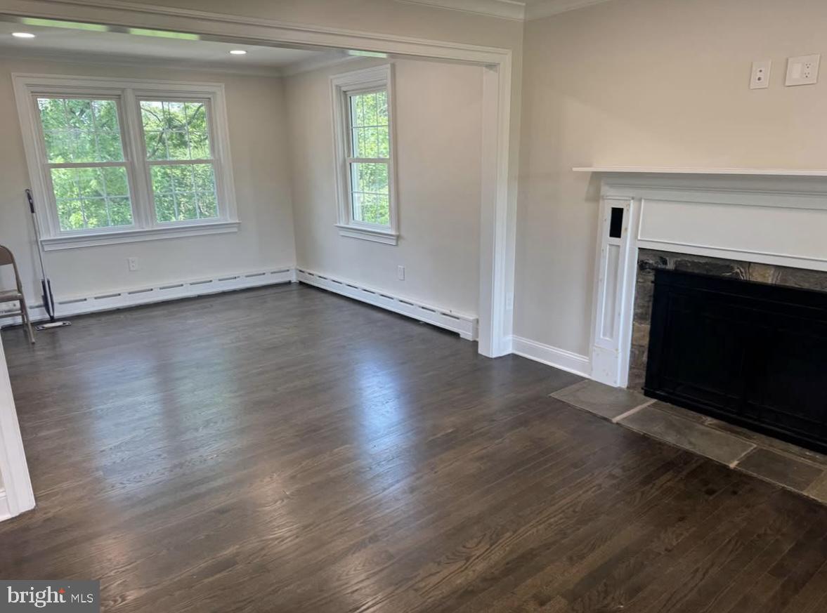 55 Apple Hill Road Furlong, PA 18925 - Photo 9 of 30 an empty room with wooden floor fireplace and windows