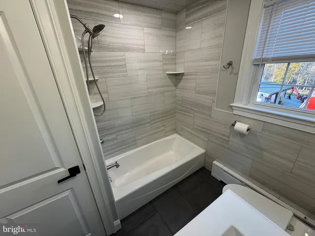 a bathroom with a bathtub and a shower
