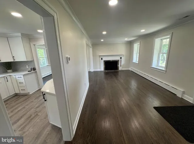 wooden floor in an empty room with a fireplace