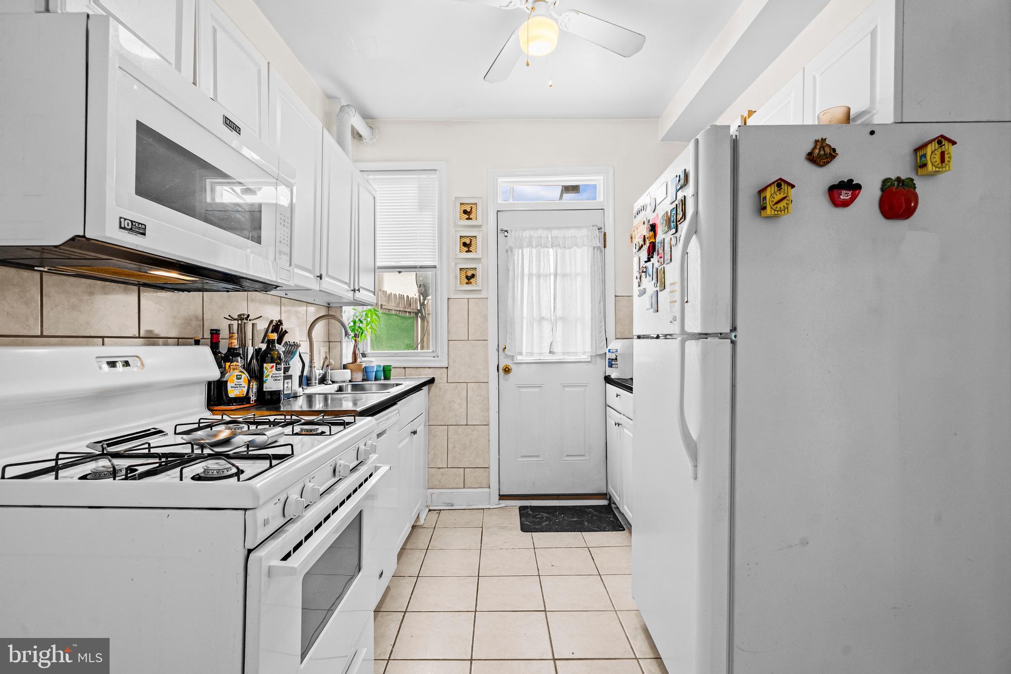 504 Kenyon Street Northwest Washington, DC 20010 - Photo 11 of 38 a kitchen with a refrigerator and a stove
