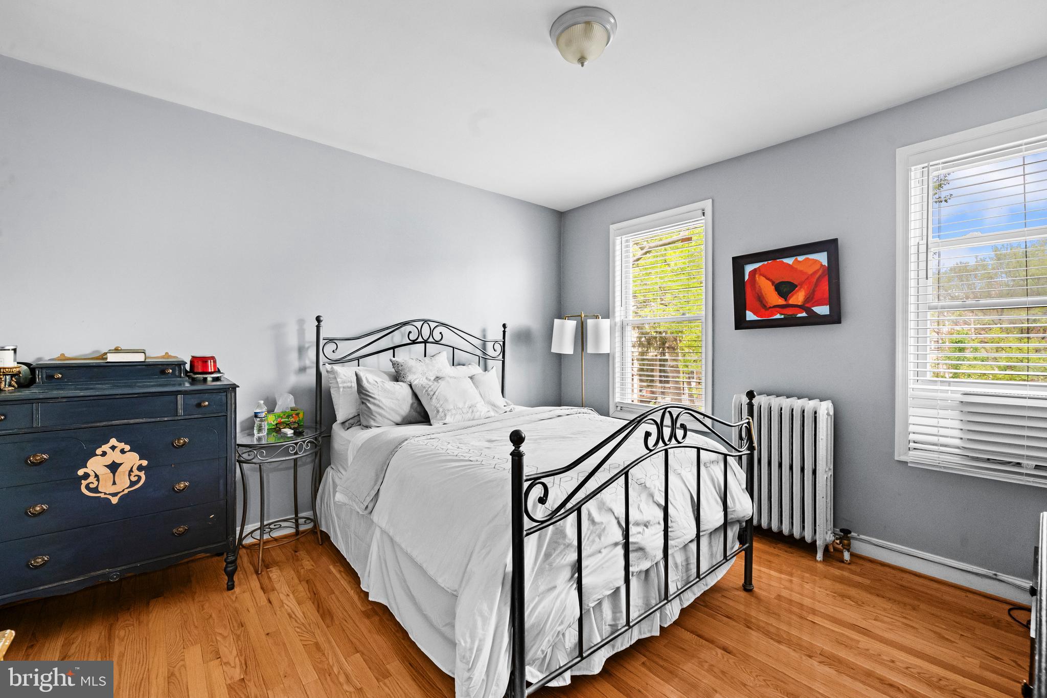504 Kenyon Street Northwest Washington, DC 20010 - Photo 15 of 38 a bedroom with a bed and wooden floor