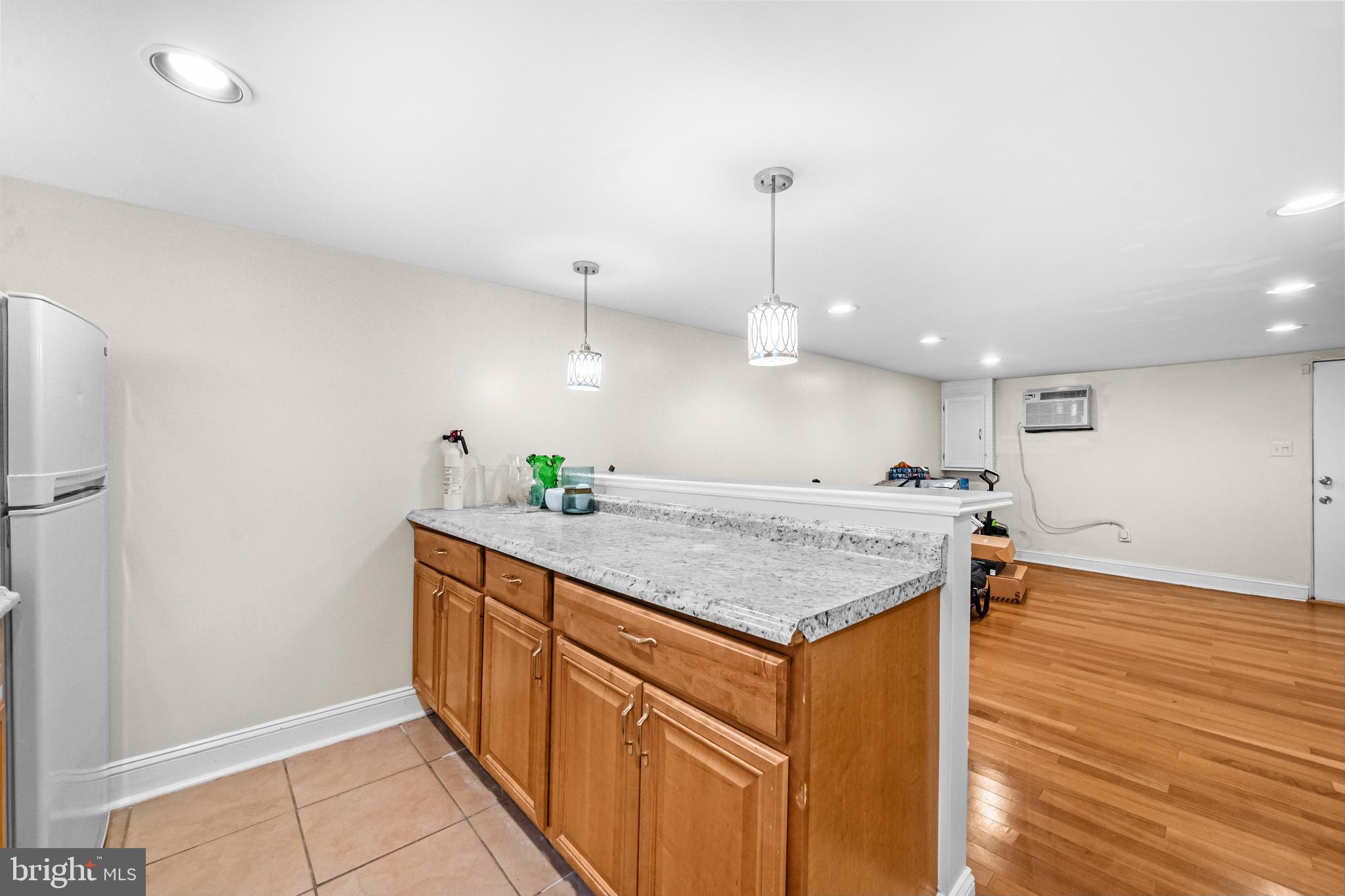 504 Kenyon Street Northwest Washington, DC 20010 - Photo 28 of 38 a kitchen with stainless steel appliances granite countertop a sink a counter space and wooden floor