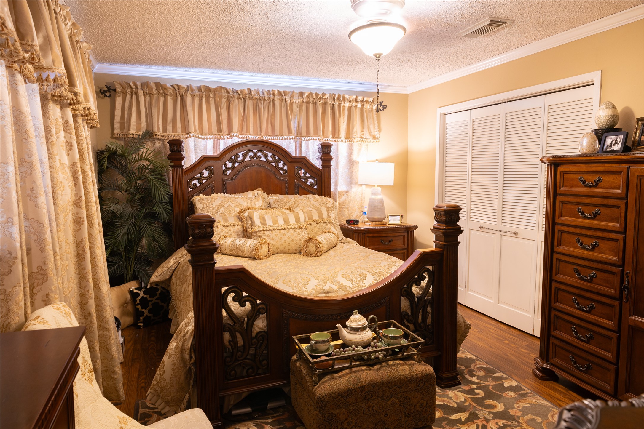 318 Peach Point Road Jones Creek, TX 77541 - Photo 13 of 27 a view of a bedroom with furniture window and wooden floor