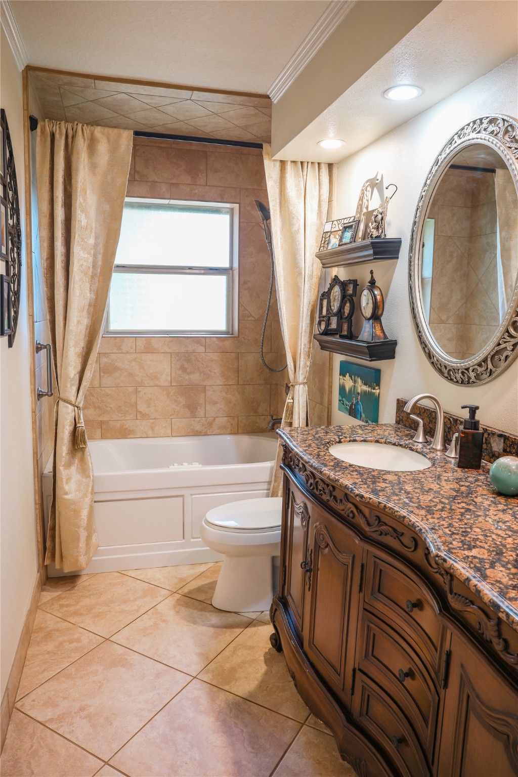 318 Peach Point Road Jones Creek, TX 77541 - Photo 18 of 27 a bathroom with a granite countertop sink a toilet and bathtub