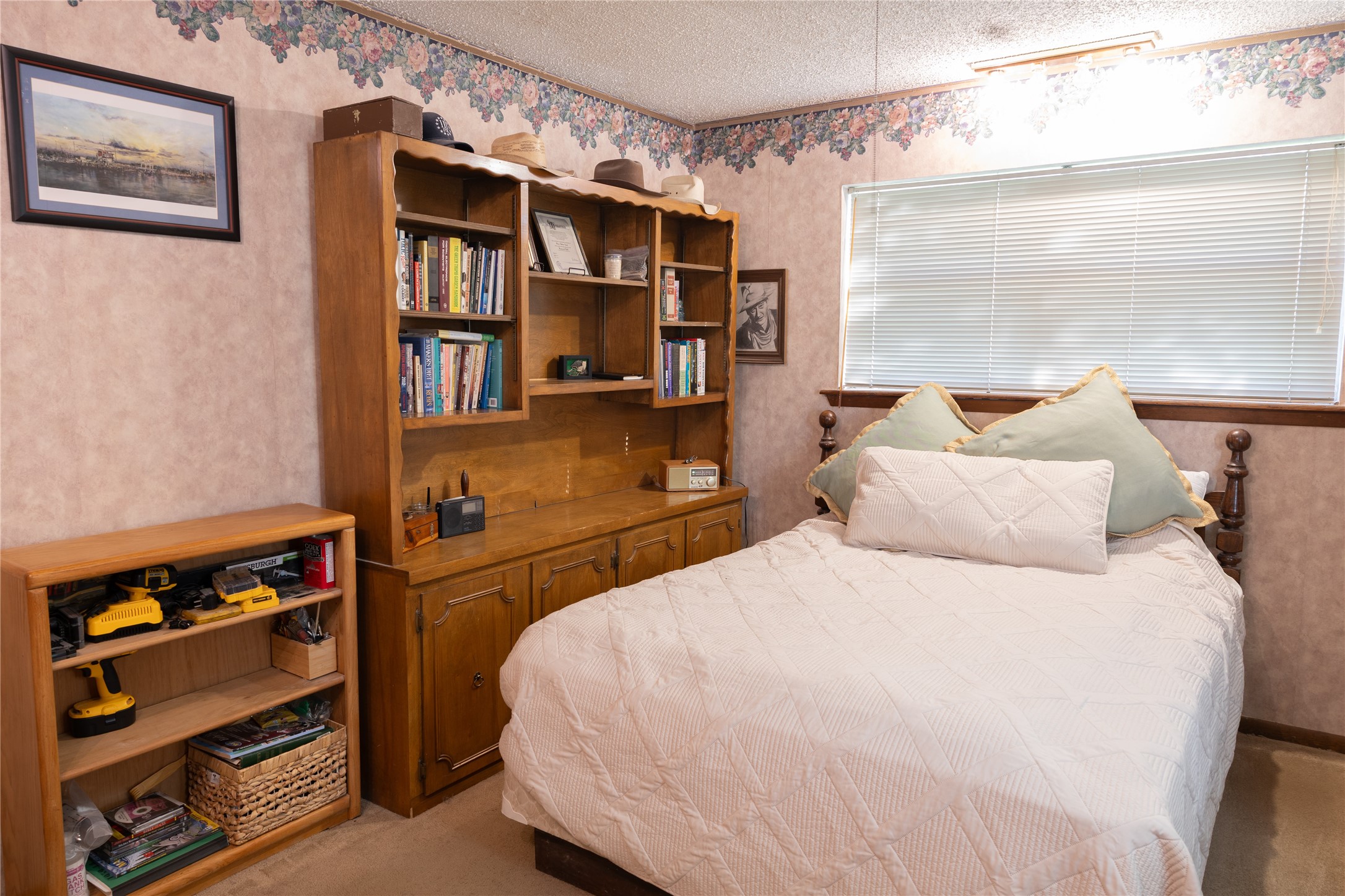 318 Peach Point Road Jones Creek, TX 77541 - Photo 20 of 27 a bedroom with a bed and a window