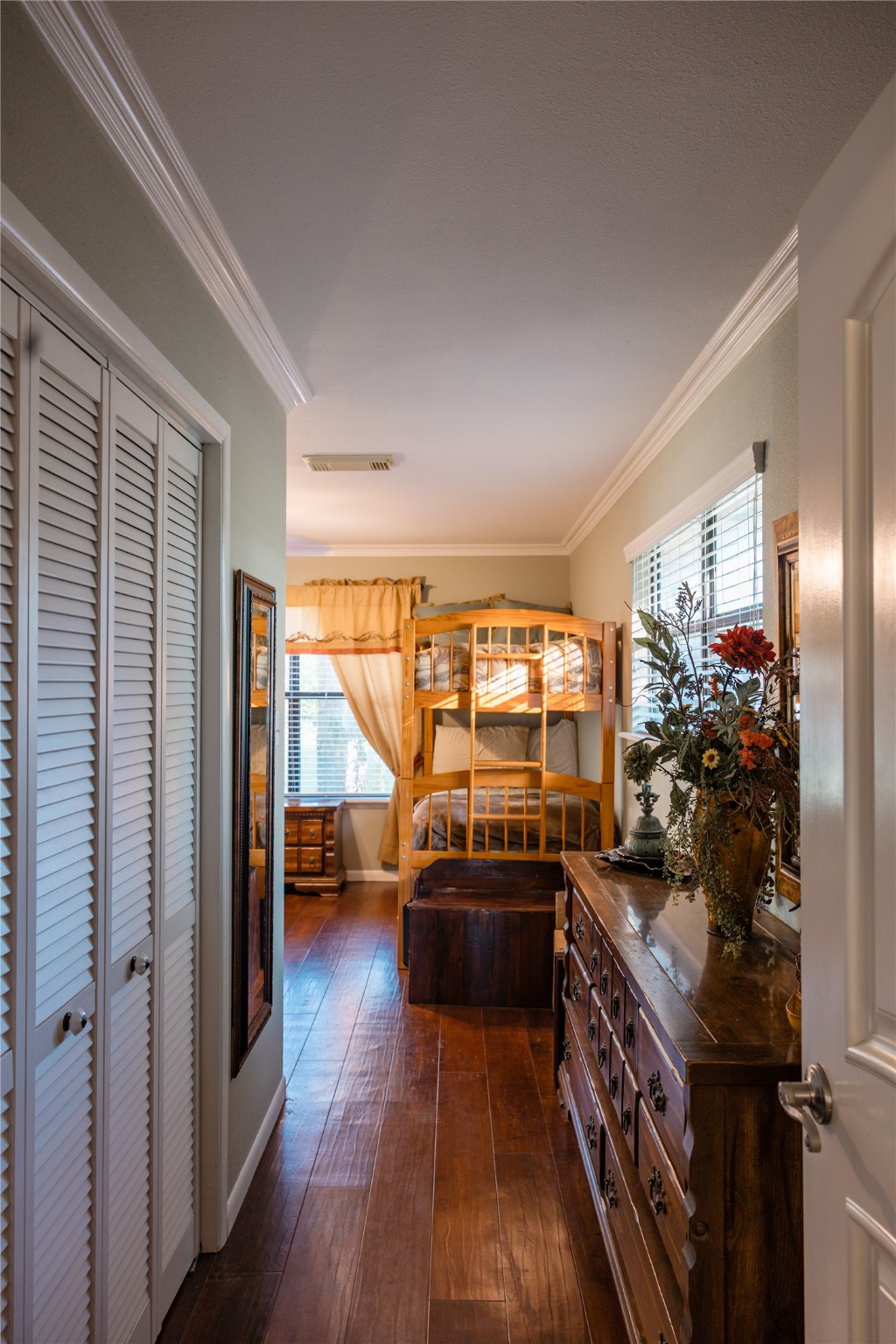 318 Peach Point Road Jones Creek, TX 77541 - Photo 22 of 27 a very nice looking room with a large window and wooden floor