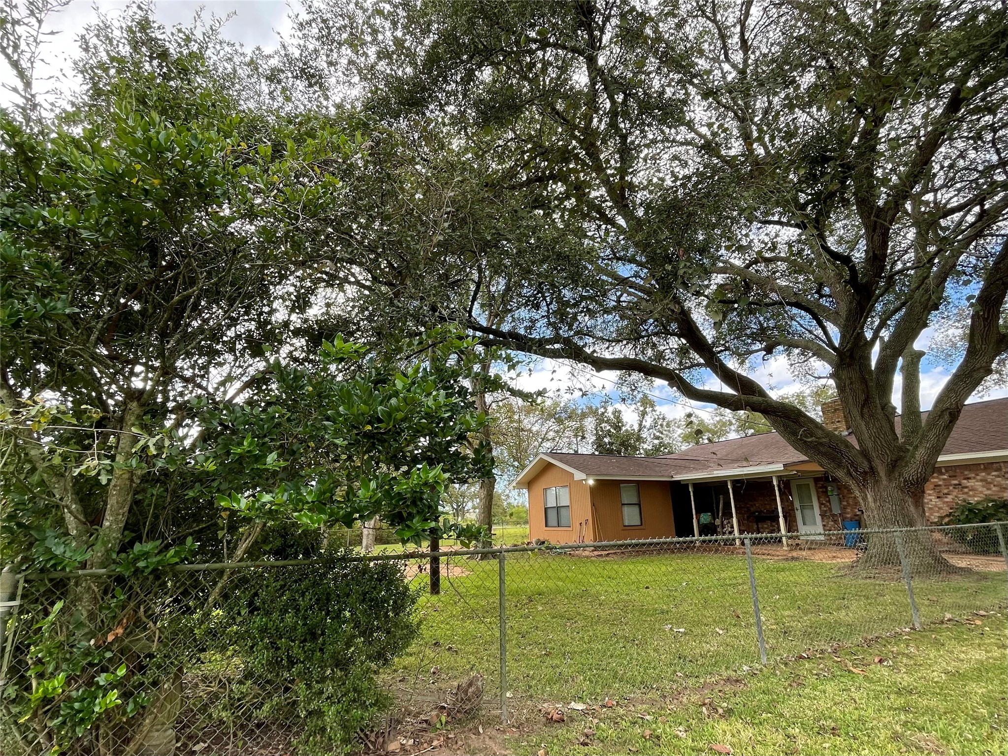 318 Peach Point Road Jones Creek, TX 77541 - Photo 25 of 27 a front view of a house with a garden
