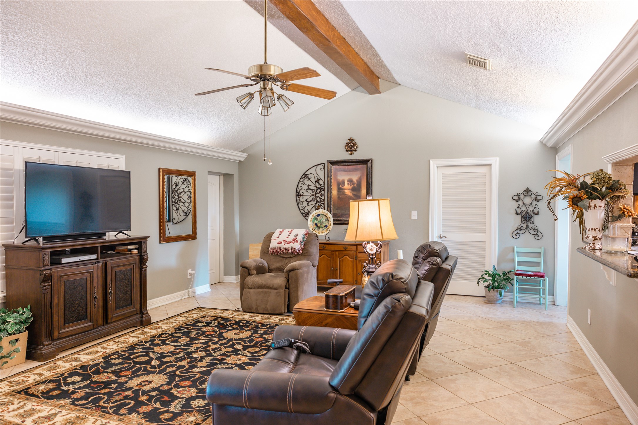 318 Peach Point Road Jones Creek, TX 77541 - Photo 5 of 27 a living room with furniture and a flat screen tv