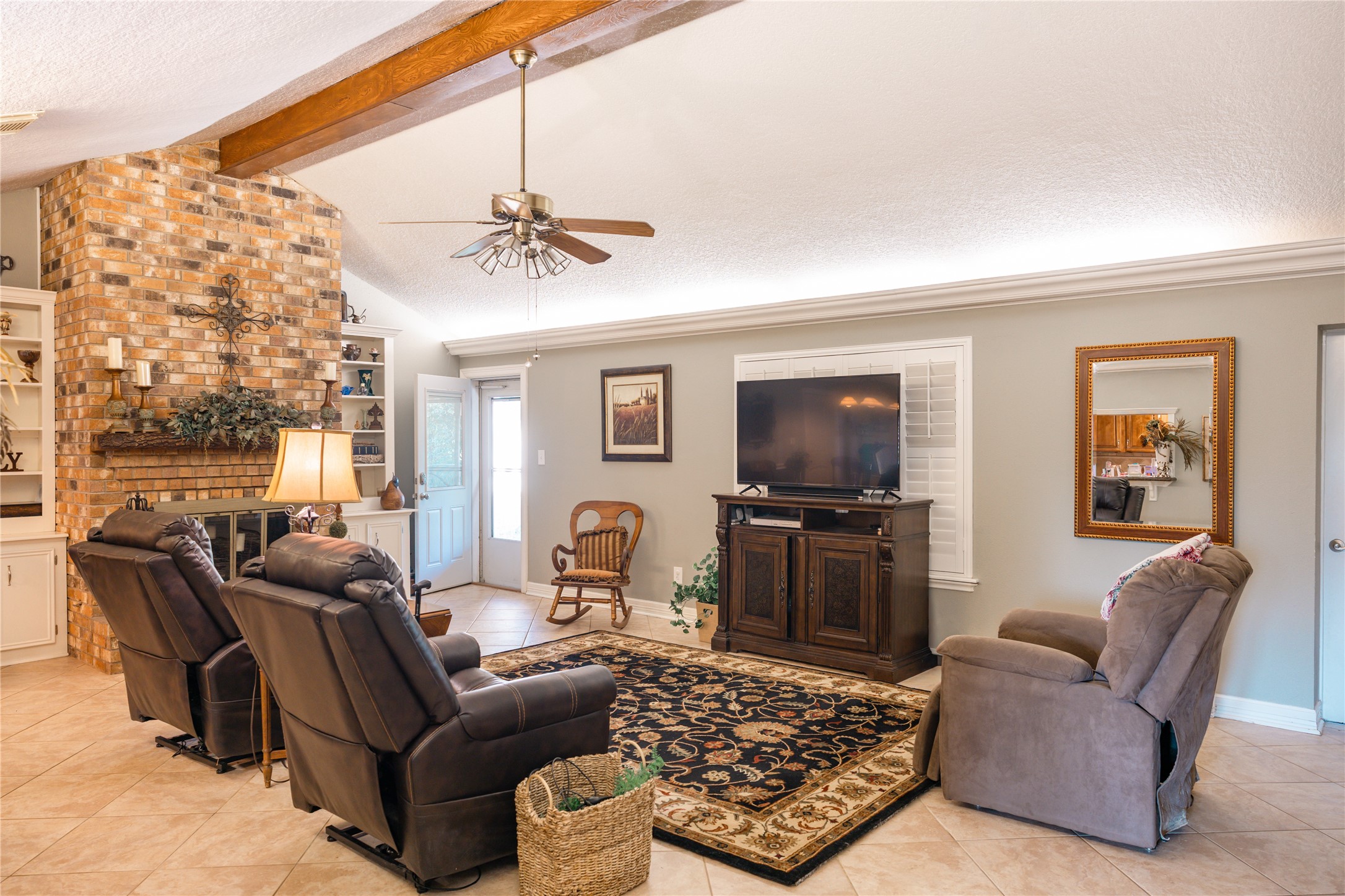 318 Peach Point Road Jones Creek, TX 77541 - Photo 7 of 27 a living room with furniture a flat screen tv and a window
