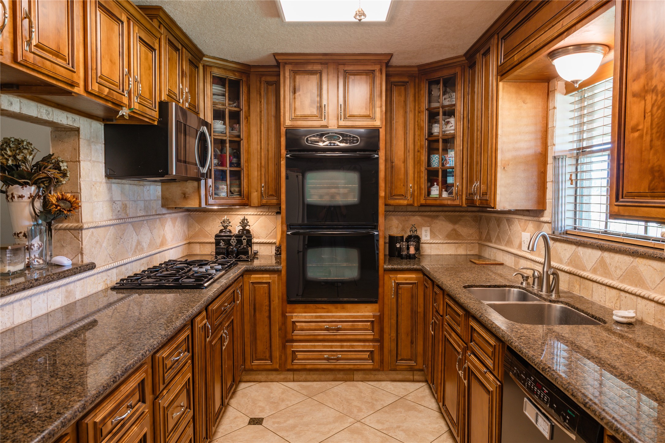 318 Peach Point Road Jones Creek, TX 77541 - Photo 10 of 27 a kitchen with granite countertop stainless steel appliances and sink