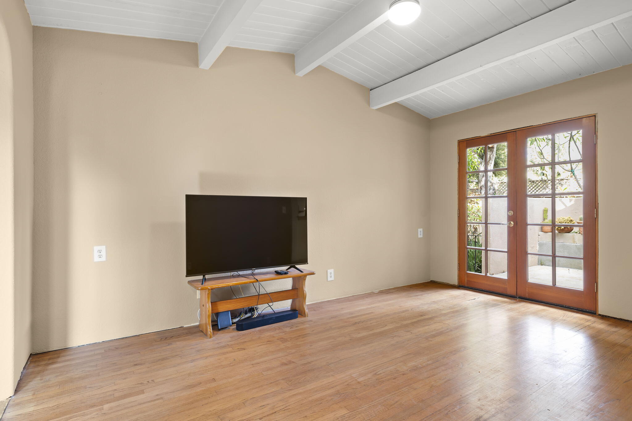 5130 Cathedral Oaks Road Santa Barbara, CA 93111 - Photo 12 of 68 a view of an empty room with wooden floor and windows