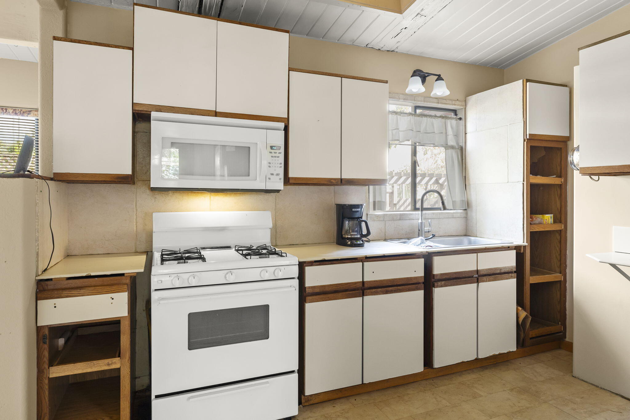 5130 Cathedral Oaks Road Santa Barbara, CA 93111 - Photo 18 of 68 a kitchen with cabinets appliances and a sink