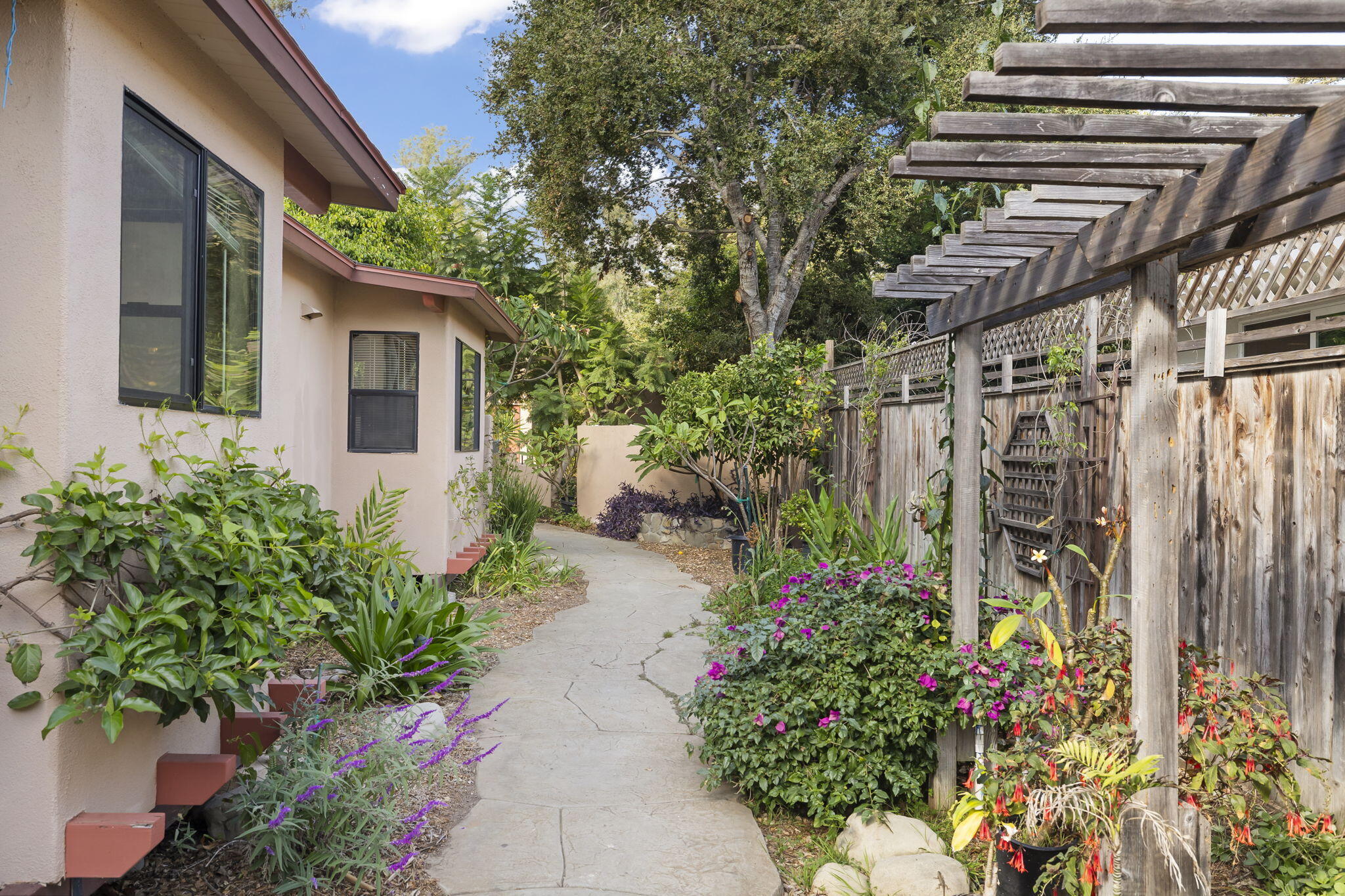 5130 Cathedral Oaks Road Santa Barbara, CA 93111 - Photo 2 of 68 a view of a pathway with flower plants