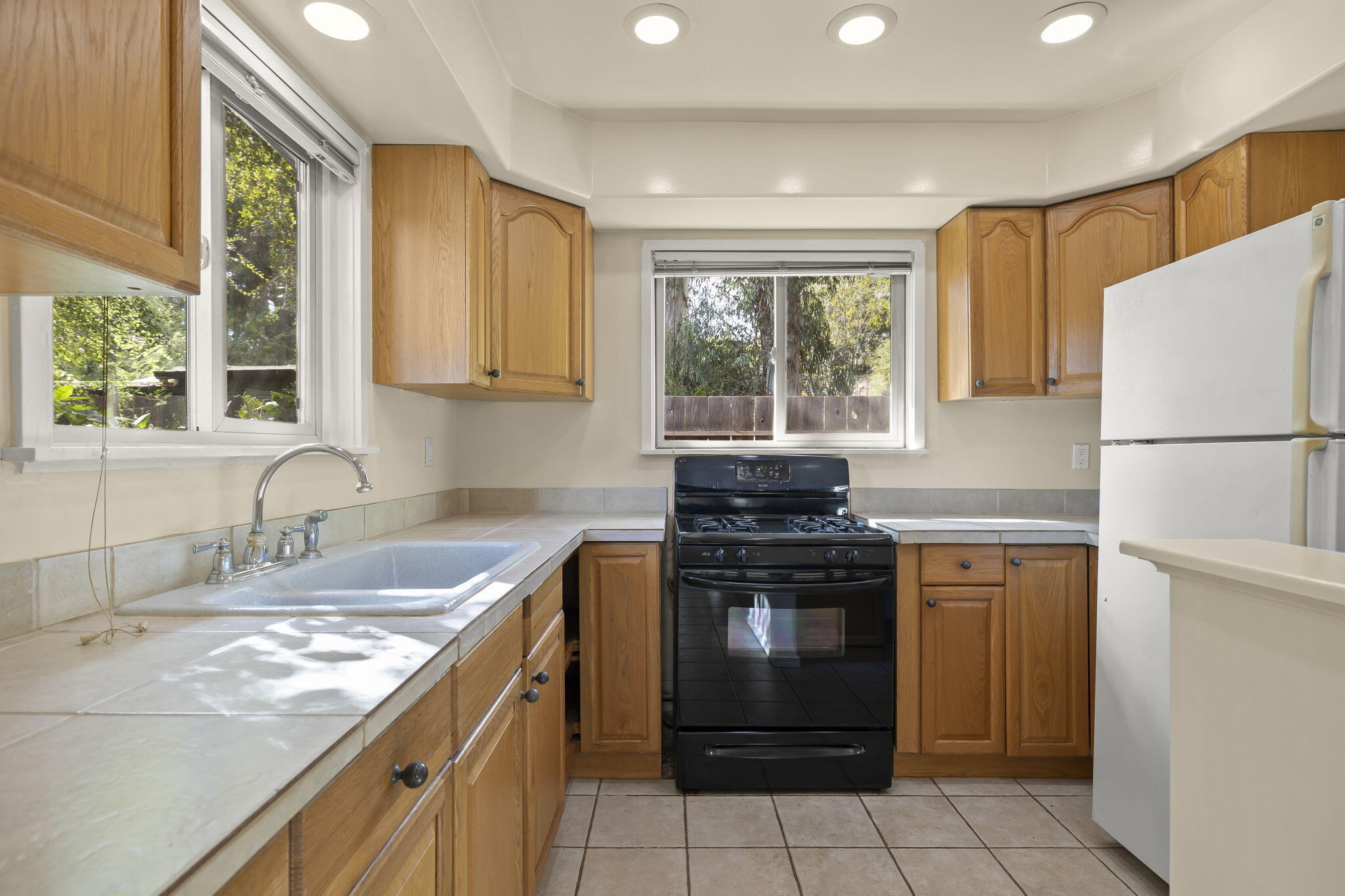 5130 Cathedral Oaks Road Santa Barbara, CA 93111 - Photo 38 of 68 a kitchen with a stove a sink and a refrigerator