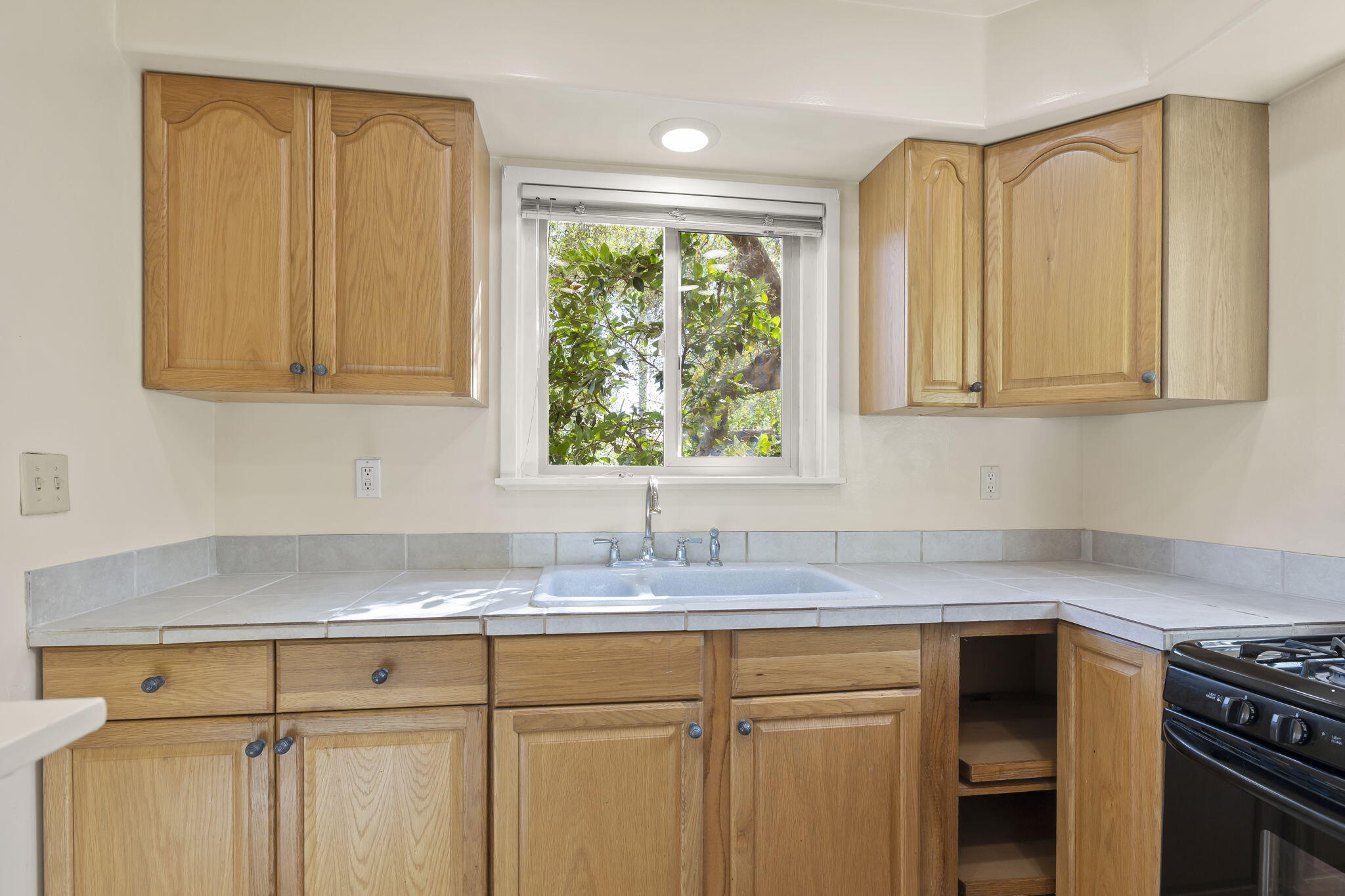 5130 Cathedral Oaks Road Santa Barbara, CA 93111 - Photo 39 of 68 a kitchen with granite countertop a sink cabinets and window