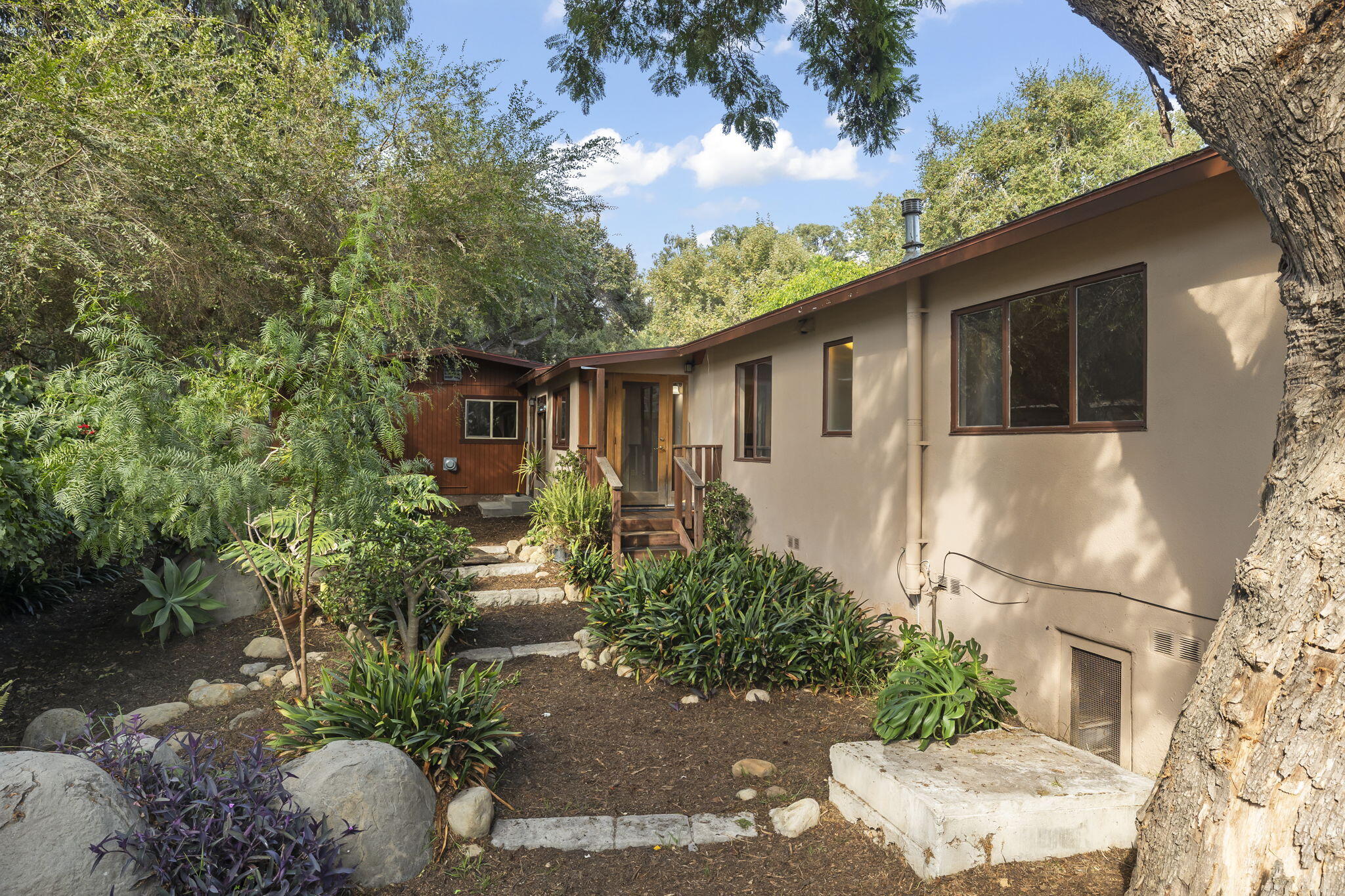5130 Cathedral Oaks Road Santa Barbara, CA 93111 - Photo 4 of 68 a front view of a house with garden