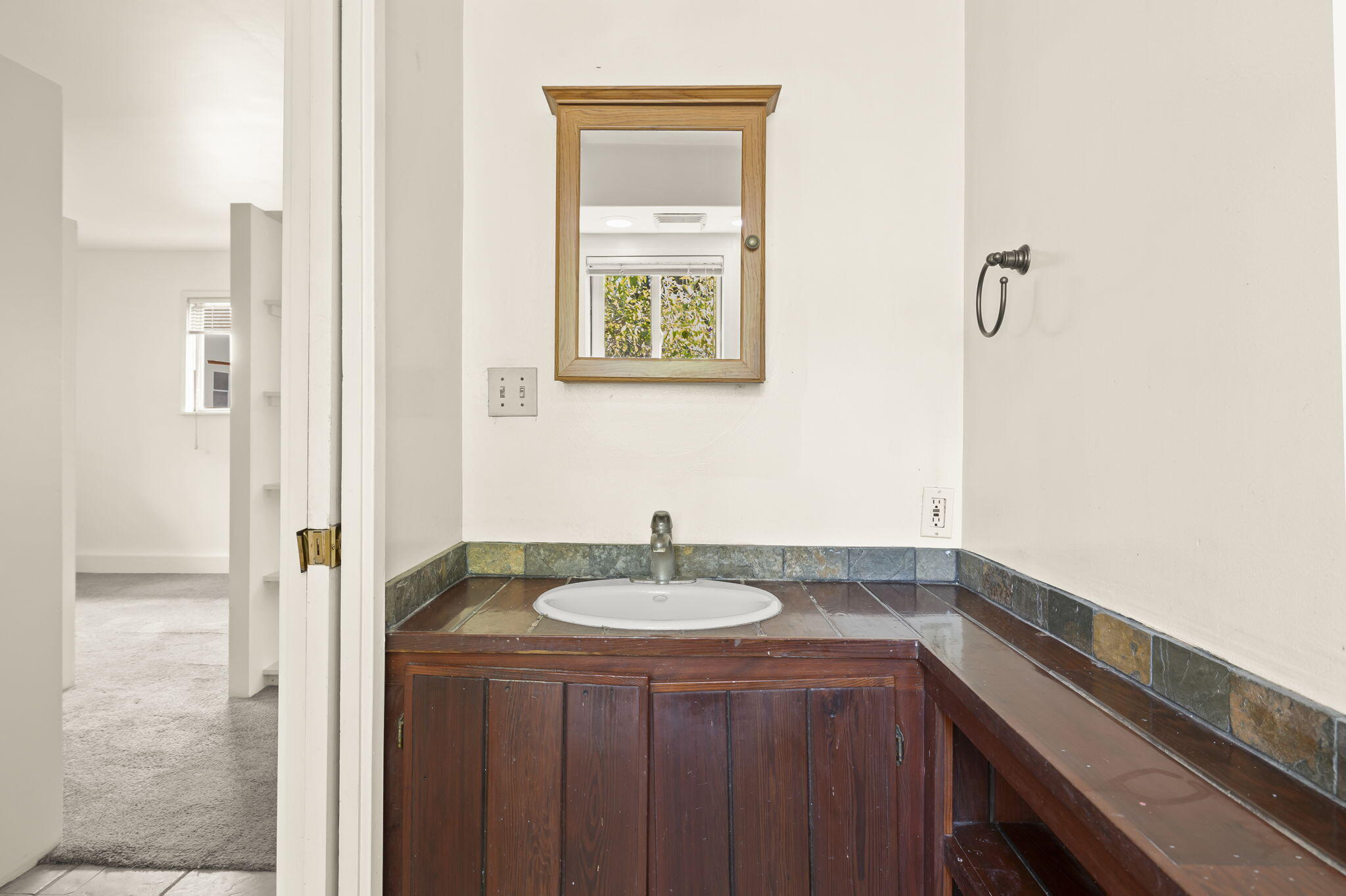 5130 Cathedral Oaks Road Santa Barbara, CA 93111 - Photo 46 of 68 a bathroom with a sink and a mirror