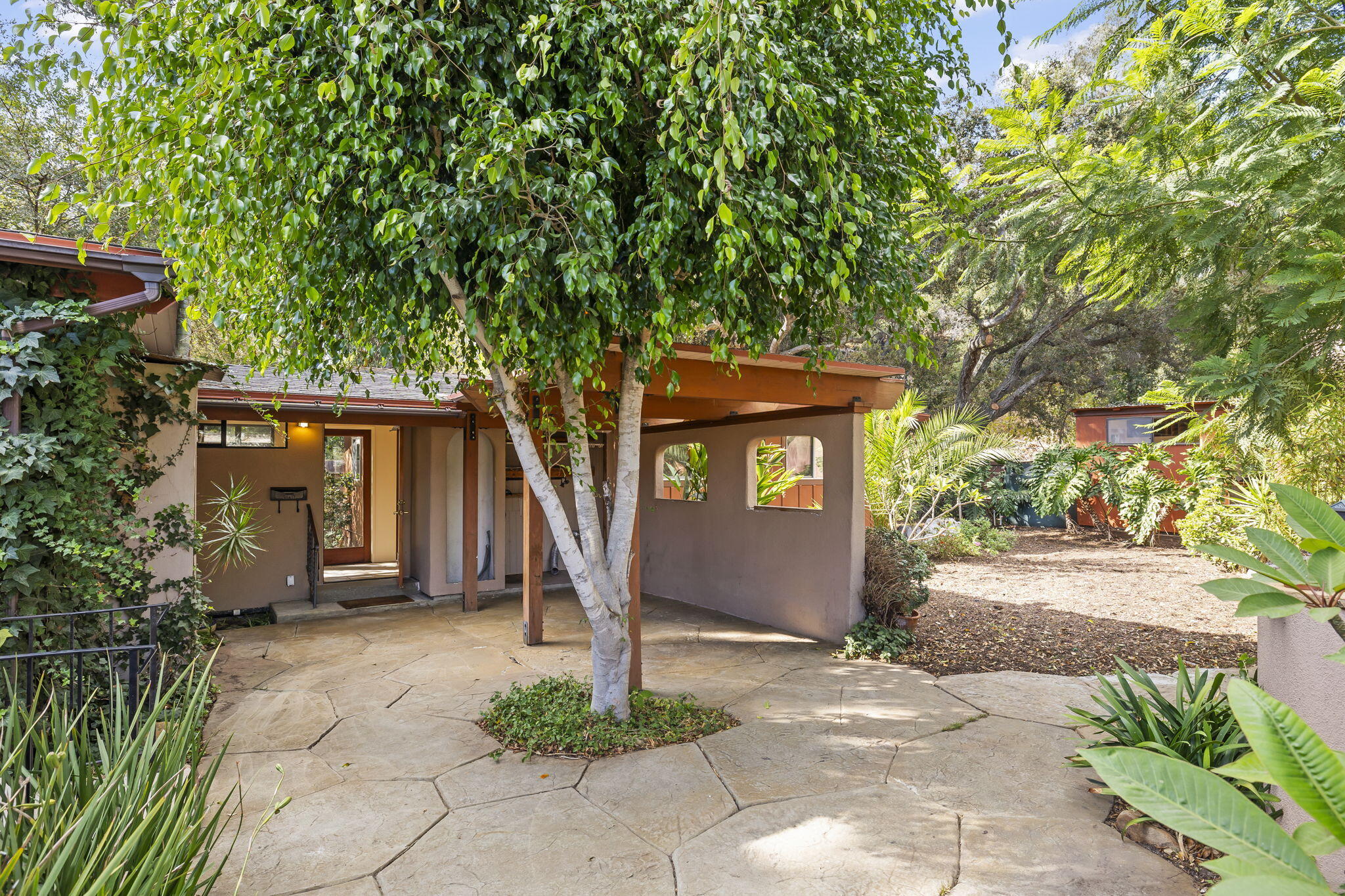 5130 Cathedral Oaks Road Santa Barbara, CA 93111 - Photo 49 of 68 a front view of a house with a yard