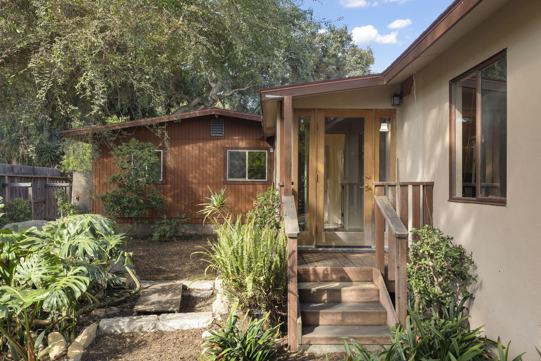 5130 Cathedral Oaks Road Santa Barbara, CA 93111 - Photo 5 of 68 a front view of a house with a garden
