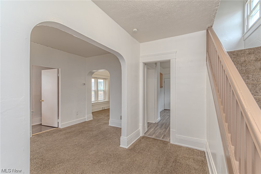 471 Rentschler Street Akron, OH 44304 - Photo 3 of 16 Hallway with a textured ceiling and carpet