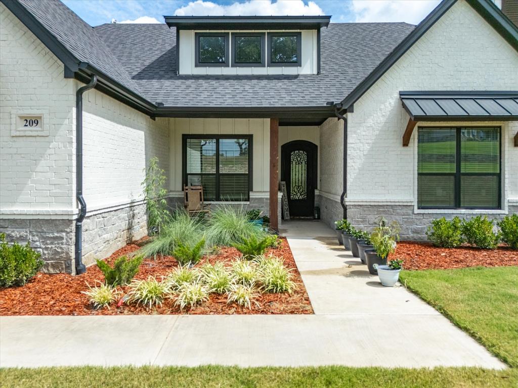 209 Rio Rancho Drive Decatur, TX 76234 - Photo 2 of 34 a front view of a house with a yard