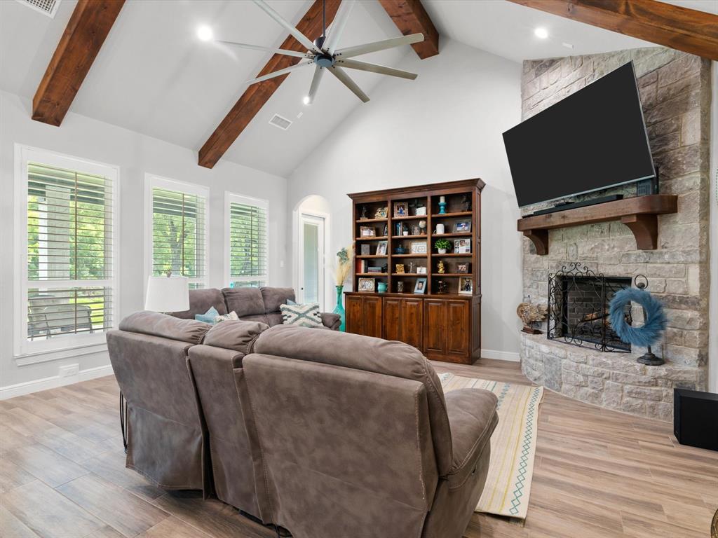 209 Rio Rancho Drive Decatur, TX 76234 - Photo 8 of 34 a living room with furniture a flat screen tv and a fireplace