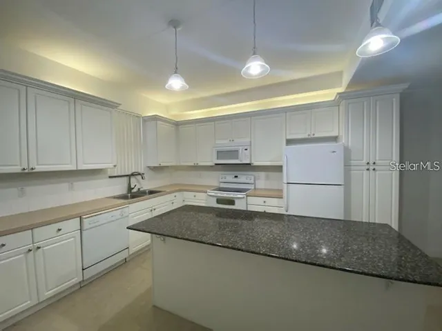 a kitchen with a sink stainless steel appliances and cabinets