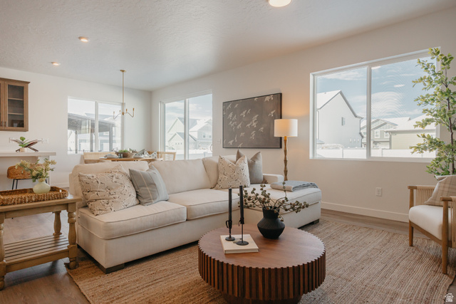 4595 North Fallow Way, Unit 511 Eagle Mountain, UT 84005 - Photo 18 of 32 Living area with hanging lights and light wood finished floors