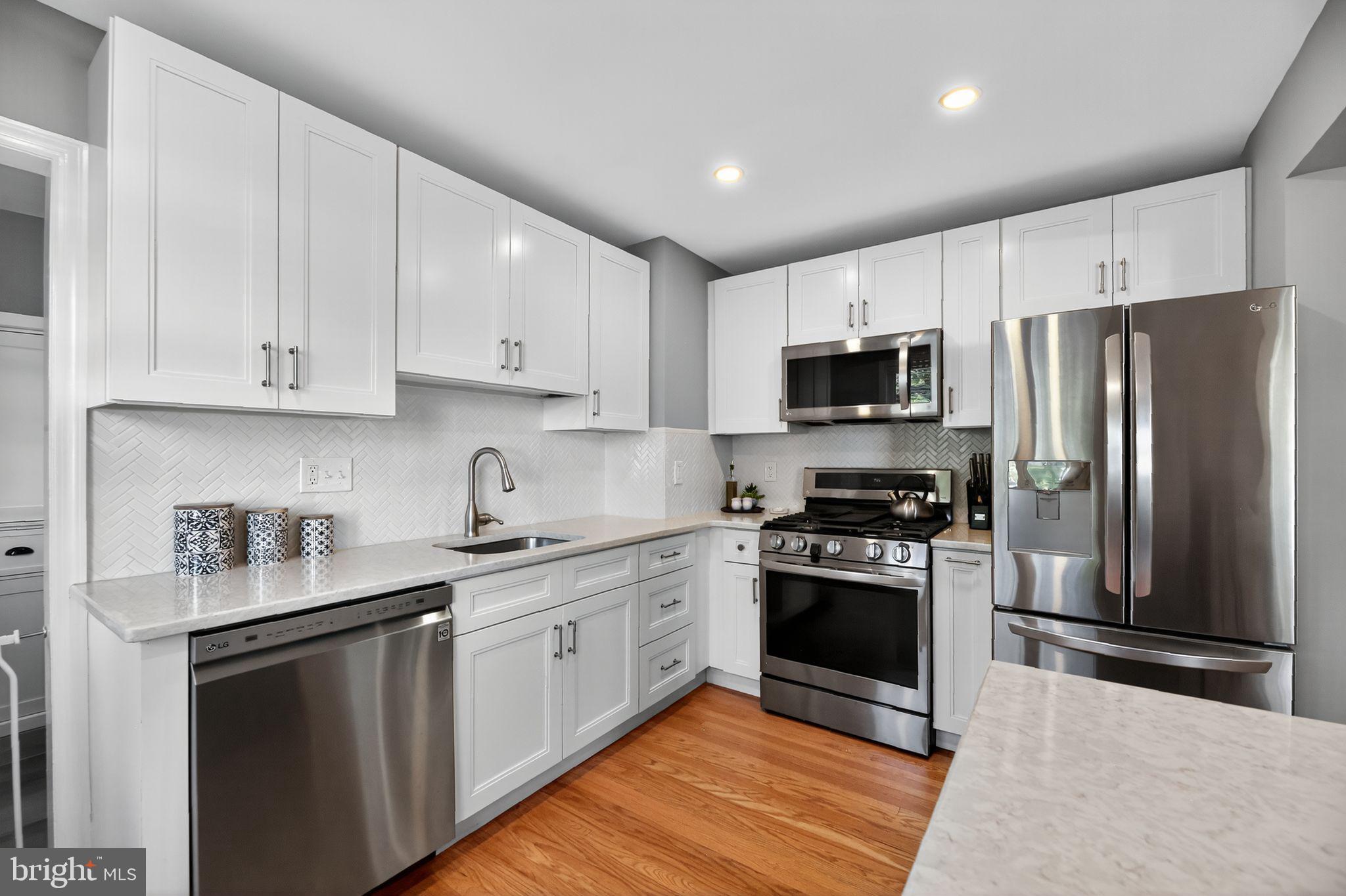 1201 Wayne Road Haddonfield, NJ 08033 - Photo 12 of 36 a kitchen with stainless steel appliances granite countertop a stove a sink and a refrigerator