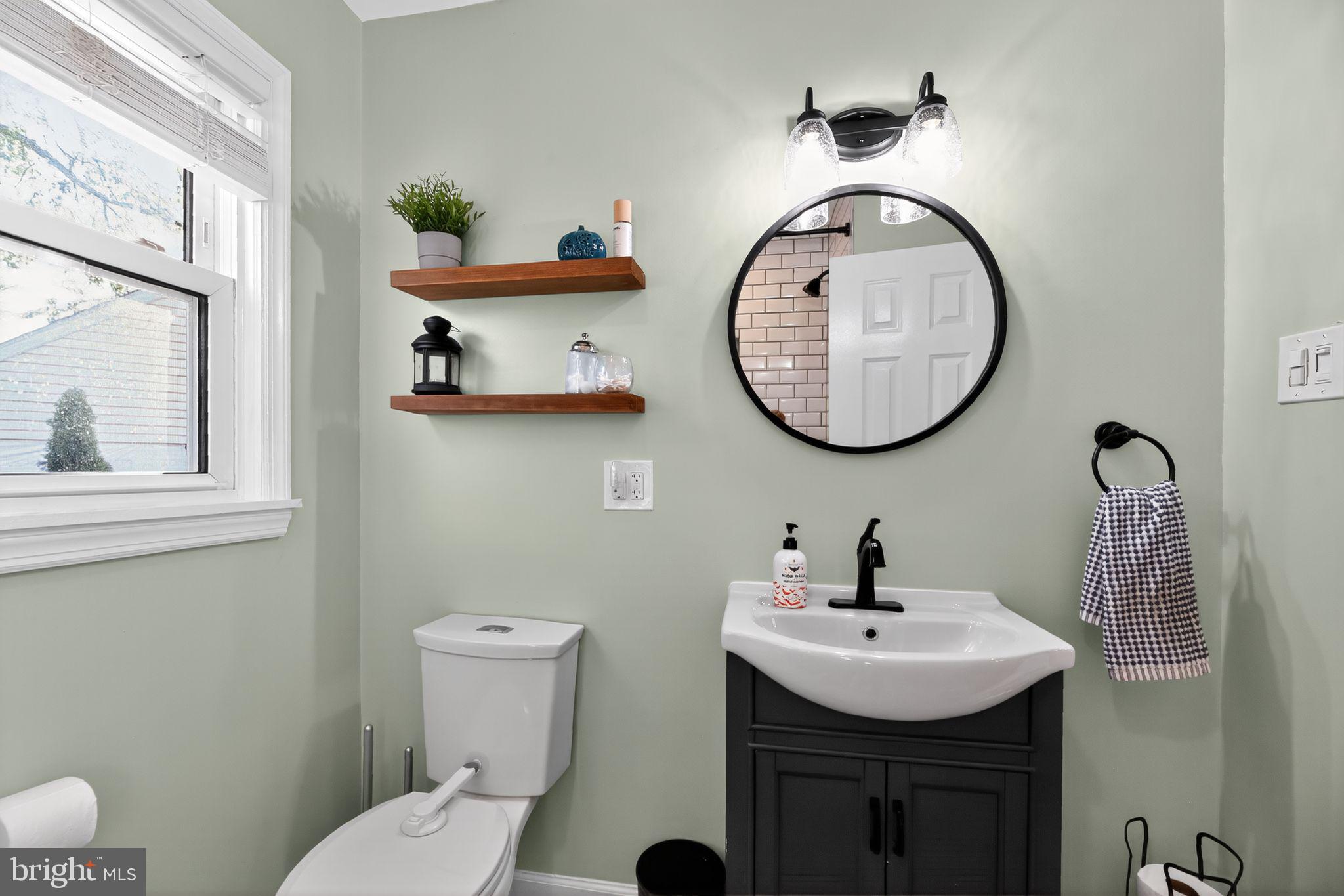 1201 Wayne Road Haddonfield, NJ 08033 - Photo 21 of 36 a bathroom with a sink a mirror and a toilet