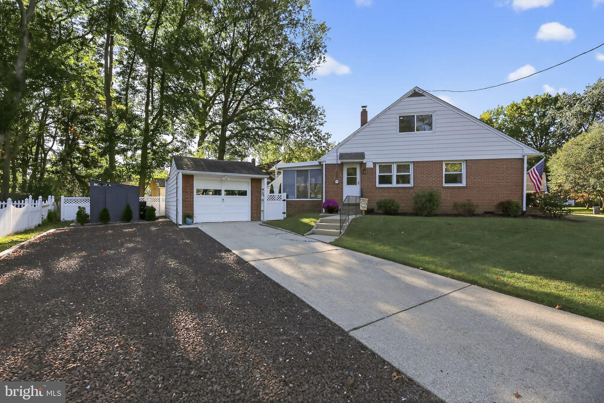 1201 Wayne Road Haddonfield, NJ 08033 - Photo 4 of 36 a front view of a house with a yard and garage