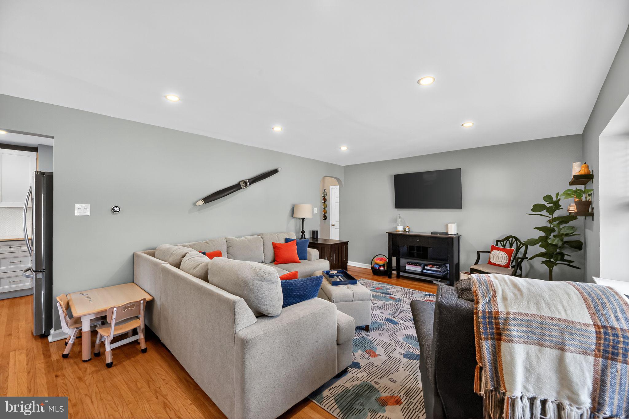 1201 Wayne Road Haddonfield, NJ 08033 - Photo 5 of 36 a living room with fireplace furniture and a flat screen tv