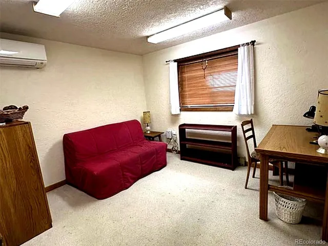 a living room with furniture a dining table and a piano