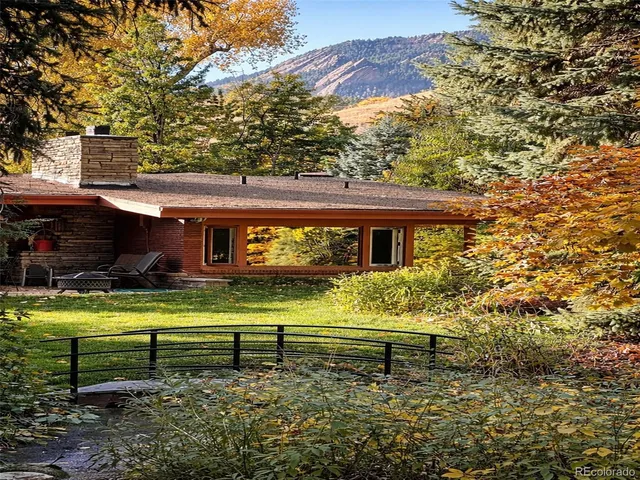 a view of a dry yard with wooden fence