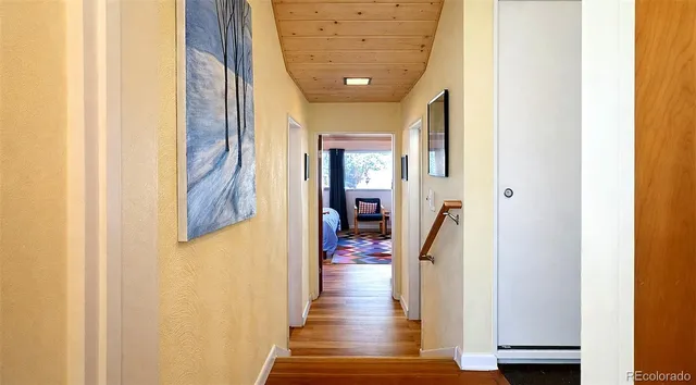 a view of hallway with wooden floor
