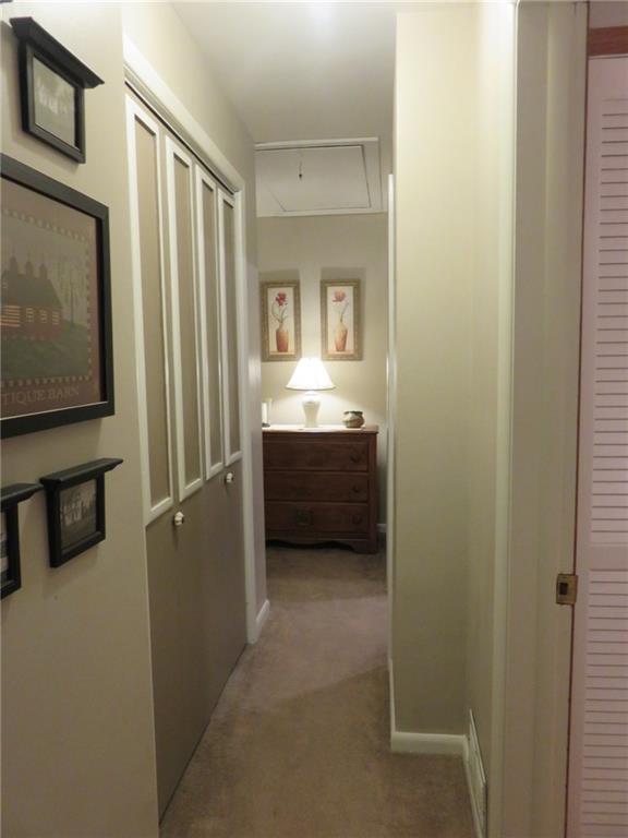 611 New Castle Road Slippery Rock, PA 16057 - Photo 13 of 24 The hallway to the third bedroom has a double storage closet and pull down attic.